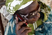 Senegalese woman conducting business by mobile phone: Demand for technical assistance to help strengthen banking and other financial systems is rising (photo: Philippe Lissac/Corbis) 