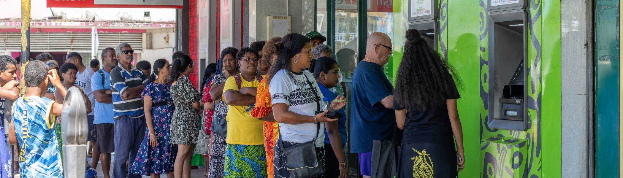 Long line of people waiting to withdraw cash from ATM in Fiji