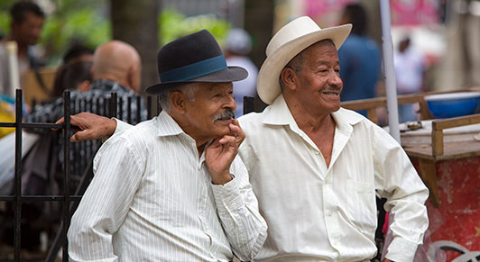 Two men sit together in a park in Medellin, Colombia: population aging in the region is expected to rise in the next few decades (photo: piccaya/iStock) 