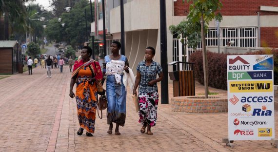 Three ladies walking down a street in Kigali, Rwanda.