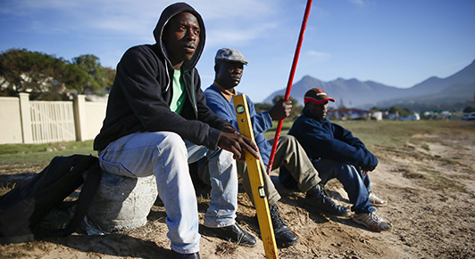  Builders and painters wait for work on a roadside in Cape Town: unemployment in South Africa is still among the highest in the world, says the IMF (photo: Nic Bothma/EPA/ Newscom) 