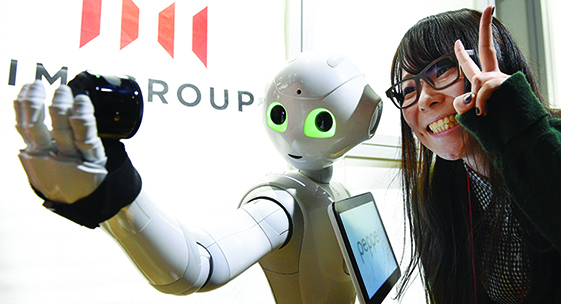 Humanoid robot Pepper takes selfie during app contest in Tokyo, Japan.