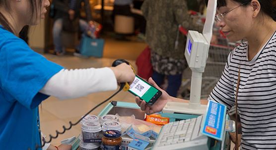 Woman buying groceries with her mobile device in Shanghai, China. The country is a global digital leader in industries like e-commerce and fintech (photo: double_p/iStock)