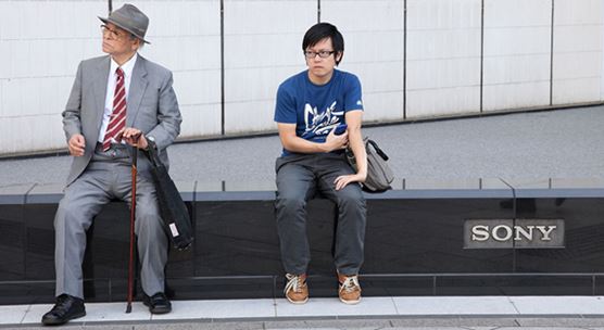 An older and a younger man sit in Tokyo’s Ginza district. By 2050 the number of aged dependents per worker will rise to about 75 percent, the highest of any country (photo: Friso Genrsch/picture alliance/Newscom)