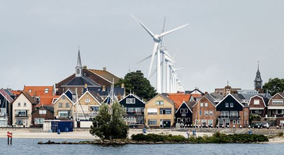 Dutch houses set against the background of a wind farm in Urk, the Netherlands, where household debt remains high (photo: Remko de Waal/ANO/Newscom)