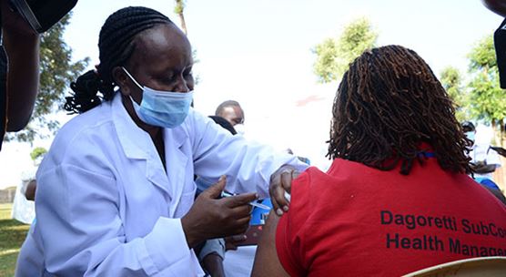 A health care worker administers a vaccine to her colleague in Nairobi,         Kenya. An IMF loan in May helped cover the cost of additional spending on health. (Photo: Dennis Sigwe / SOPA Images/Sipa/Newscom)   