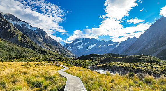 Hiking at Mount Cook National Park in New Zealand. Once COVID-19 community transmission was eliminated and lockdown measures eased, the economy rebounded rapidly in the second half of 2020. (photo: Robert CHG by Getty Images)