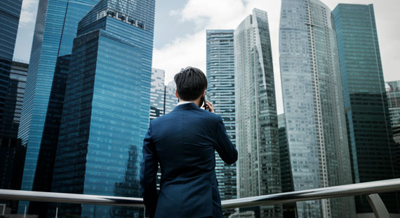 Businessman takes a phone call in Singapore. Asia is caught in a period of global policy uncertainty (photo: rawpixel/istock)