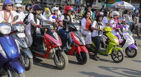Female bikers ride together on International Women's Day in Dhaka, Bangladesh, where economic growth is revving up to 7 percent this year (photo: CrowdSpark/Newscom)