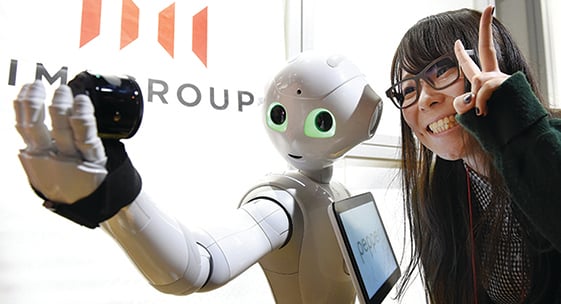 Humanoid robot Pepper takes selfie during app contest in Tokyo, Japan.
