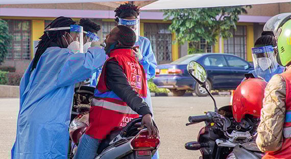A health worker takes a sample during a COVID-19 street testing survey in Kigali. Rwanda has deployed innovative measures to try to contain the virus. (photo: Cyril Ndegeya/Xinhua/Newscom)