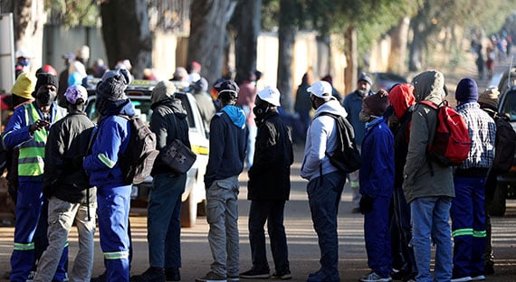 Job seekers stand outside a construction site near Johannesburg. South Africa’s unemployment rate hit a record high even before the pandemic hit. (photo: Siphiwe Sibeko/REUTERS/Newcom)