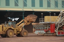 Iron ore enters conveyor on dockside in Buchanan, Liberia, where processing of ore exports is planned to rise sharply (photo: Simon Willson/IMF) 