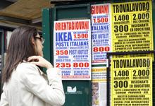 A woman checks job offers in downtown Milan.  IMF proposes improving programs that help people find work, matching jobs with  training (photo: Alessandro Garofalo/Reuters/Corbis) 