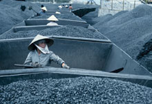 Workers unload coal from railway trucks in Halong Bay, Vietnam. Countries rich in resources must manage the profits carefully (photo: Jenny Matthews/Alamy) 