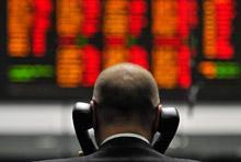 A trader in London: banks around the world are in different stages of repairing their balance sheets (photo: Andy Rain/EPA/Newscom) 