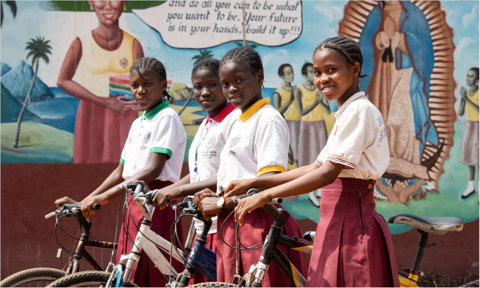 Young school girls with bicycles