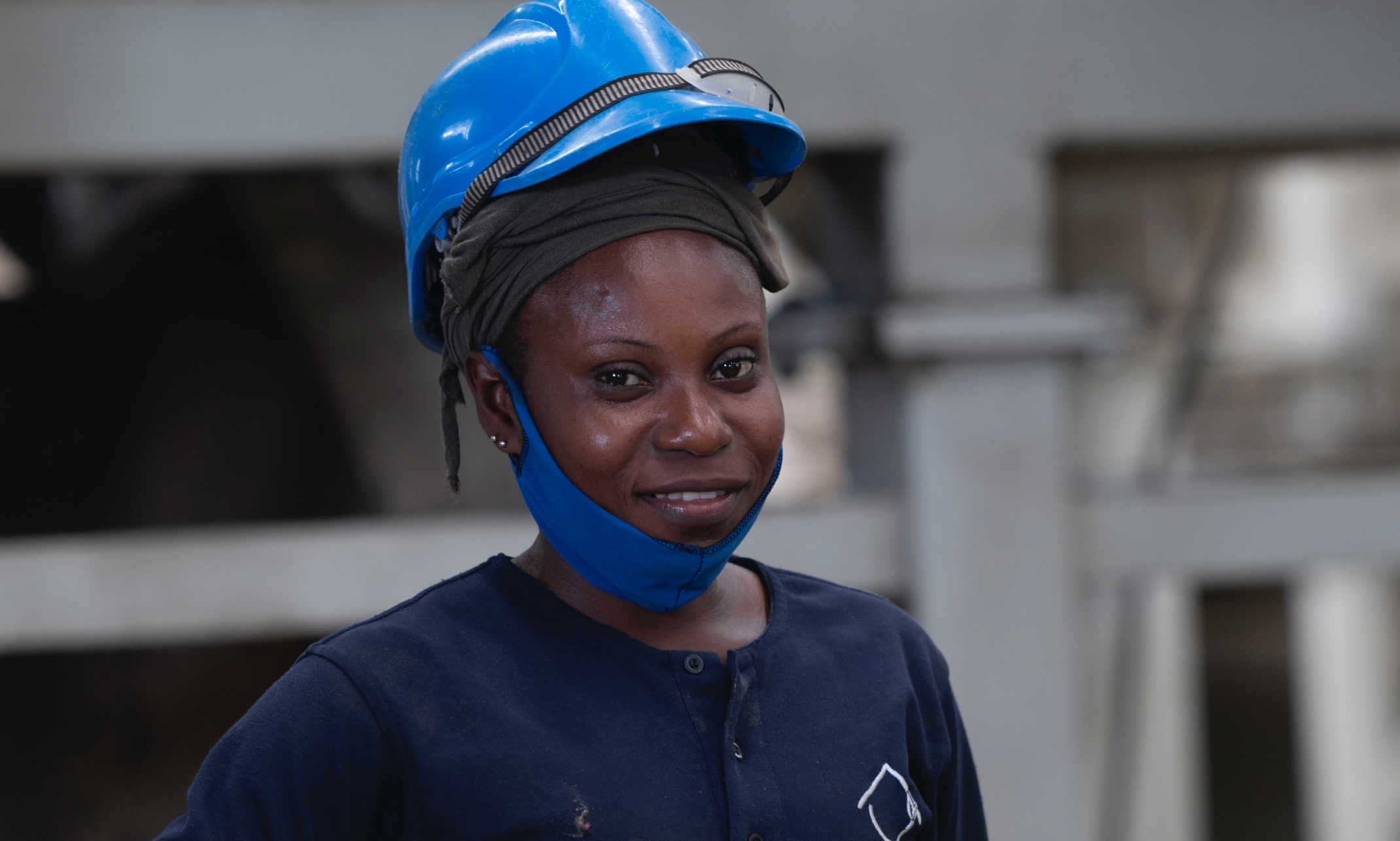 Woman on construction site wearing a hard hat