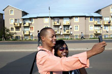 Couple takes photo with a cell phone in Soweto, South Africa.