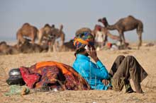 A man uses a mobile phone at a camel fair in Pushkar, India.