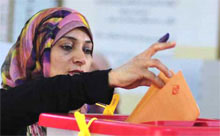 Woman casting election ballot in Tripoli, Libya.
