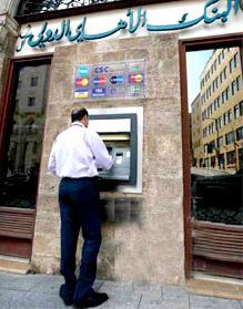 Man withdraws money from ATM in Beirut, Lebanon.