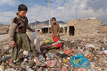 Afghan children collecting recyclables for money.