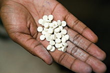 A handful of AIDS pills, Pepo La Tumaini Jangwani HIV/AIDS Community Rehabilitation Program, Orphanage & Clinic, Isiolo, Kenya. 