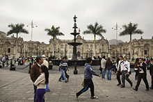 People walking past Government House, Plaza de Armas, Lima, Peru.