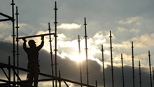A man stands on scaffolding by construction works near Munich, Germany.