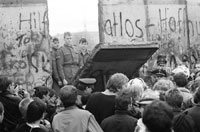 West Berliners stand in front of Berlin Wall as a section is being demolished, November 1989.