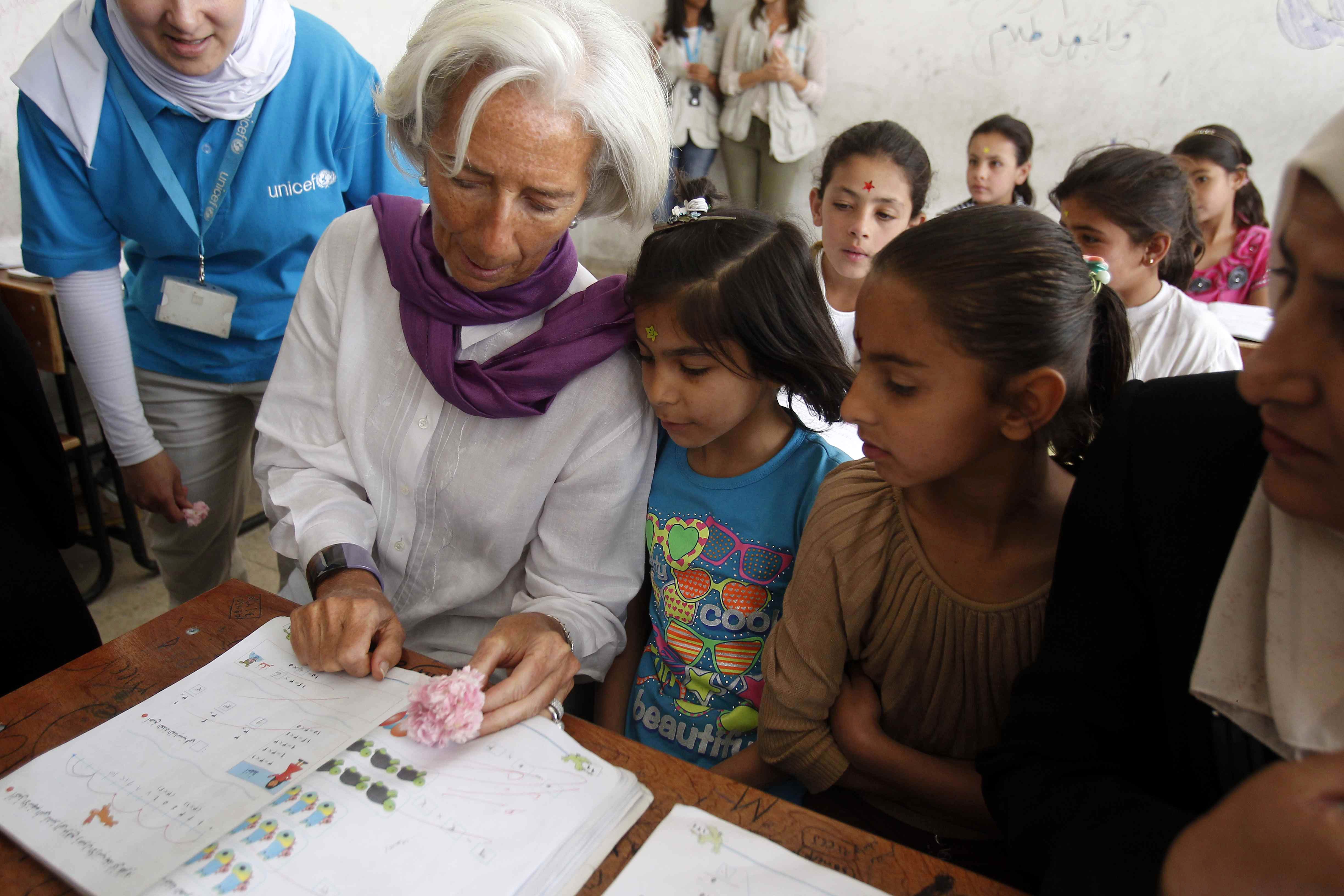 International Monetary Fund Managing Director Christine Lagarde speaking with students from the Alimate school in Mafraq, Jordan. Photo: EPA/Ali Jarekji/Pool