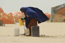 Somali woman collecting water. Since the collapse of its government, Somalia has not been able to meet some of the basic needs of its citizens (photo: Courbet/Corbis) 