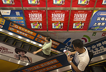 People ride escalators in an electronics store in Beijing. With China now the world’s largest economy, success is critical for China and the world (photo: Mark Schiefelbein/AP/Corbis) 