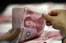 Bank teller counting renminbi: The IMF’s Executive Board has determined the Chinese currency is “freely usable” (photo: Imaginechina/Corbis) 