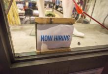 “Now Hiring” sign in window of retailer in New York City. Closing output gaps in advanced economies will reduce their unemployment and also help other countries (photo: Richard Levine/Demotix/Corbis) 